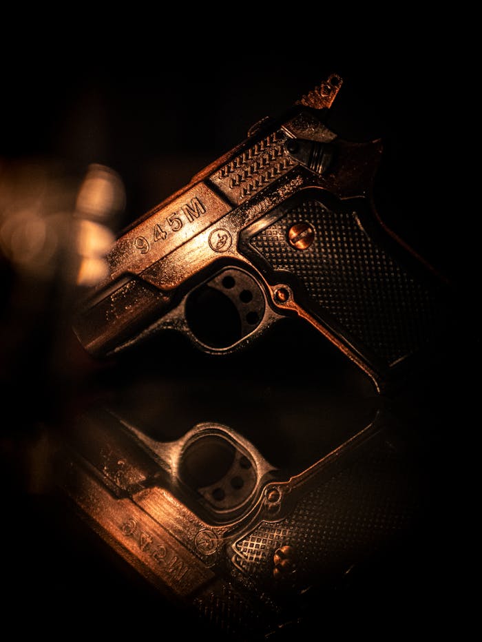 Crafting Captivating Headlines: Your awesome post title goes here Close-up of a vintage handgun reflected on a surface in low light, artfully captured.